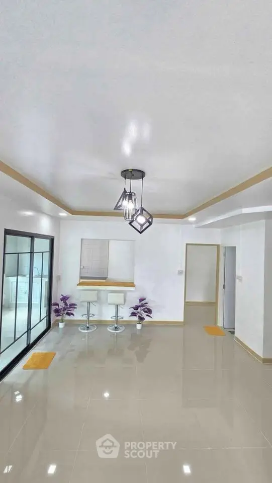 Modern minimalist living room with sleek lighting and glossy tiled floors