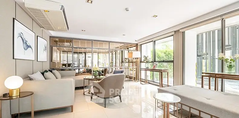 Luxurious modern living room with elegant decor and large windows offering natural light.