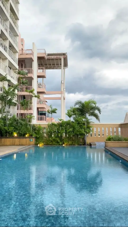 Luxurious apartment complex with a stunning outdoor pool and lush greenery.