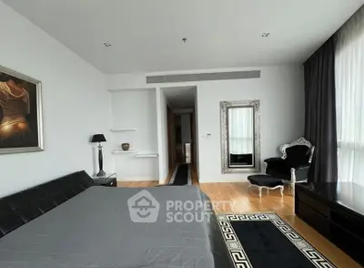 Luxurious bedroom with elegant decor and large window for natural light.