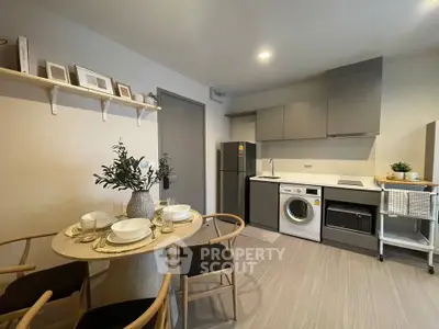 Modern kitchen with dining area, featuring sleek appliances and stylish decor, perfect for contemporary living.