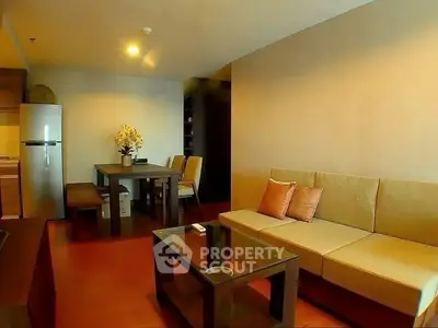 Modern living room with stylish furniture and dining area in open layout apartment.