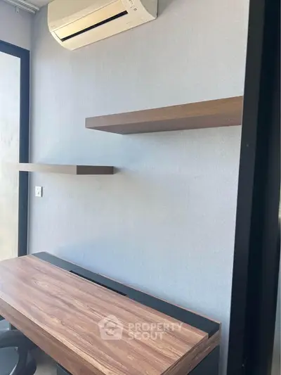 Modern study room with sleek wooden desk and floating shelves