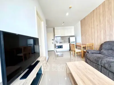 Modern living room with sleek furniture and open kitchen layout