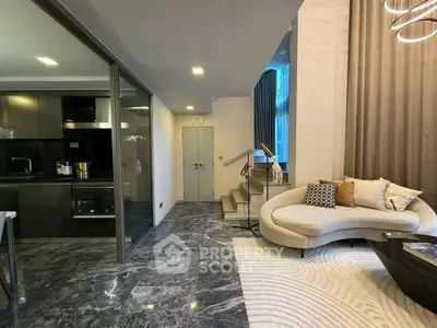 Luxurious modern living room with sleek kitchen and elegant staircase, featuring marble flooring and stylish decor.