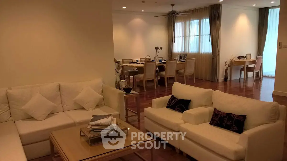 Spacious living room with elegant dining area and cozy seating, perfect for entertaining guests.