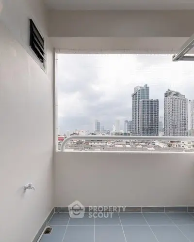 Spacious balcony with stunning city skyline view, perfect for relaxation and enjoying urban living.