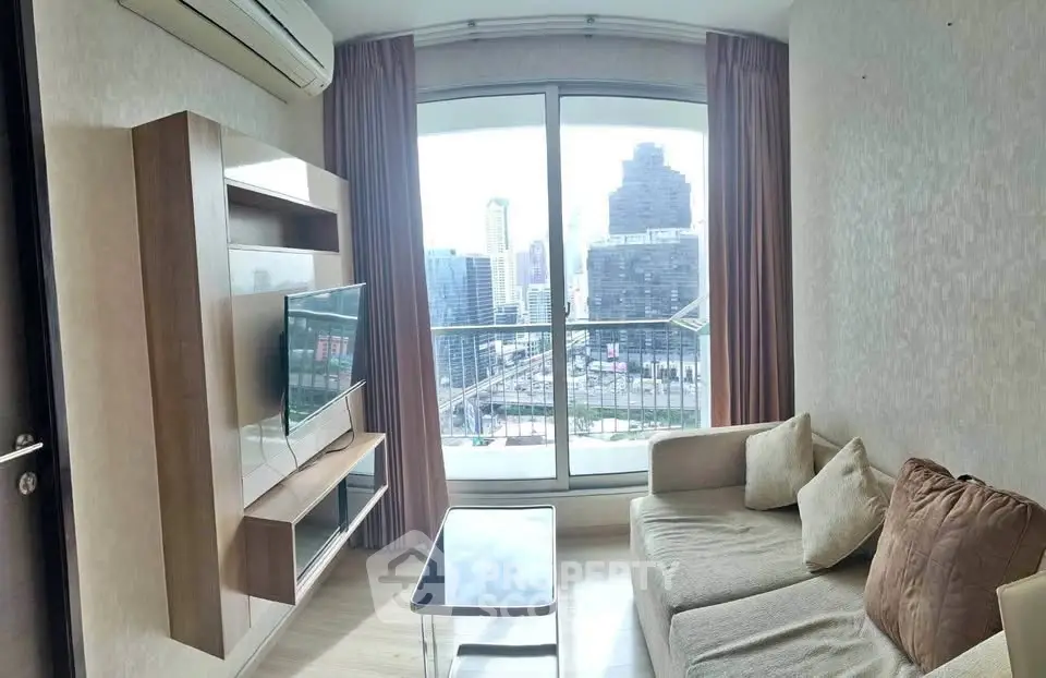 Modern living room with city view, featuring a sleek TV setup and cozy seating area.