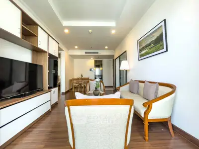 Spacious living room with elegant furniture and modern decor in a stylish apartment.