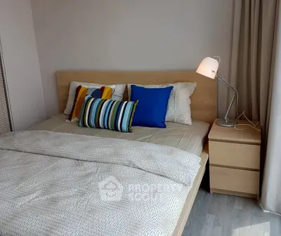 Cozy bedroom with modern decor and stylish lighting in a contemporary apartment.