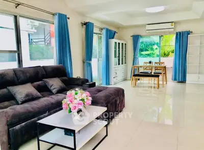 Spacious living room with modern decor and large windows for natural light