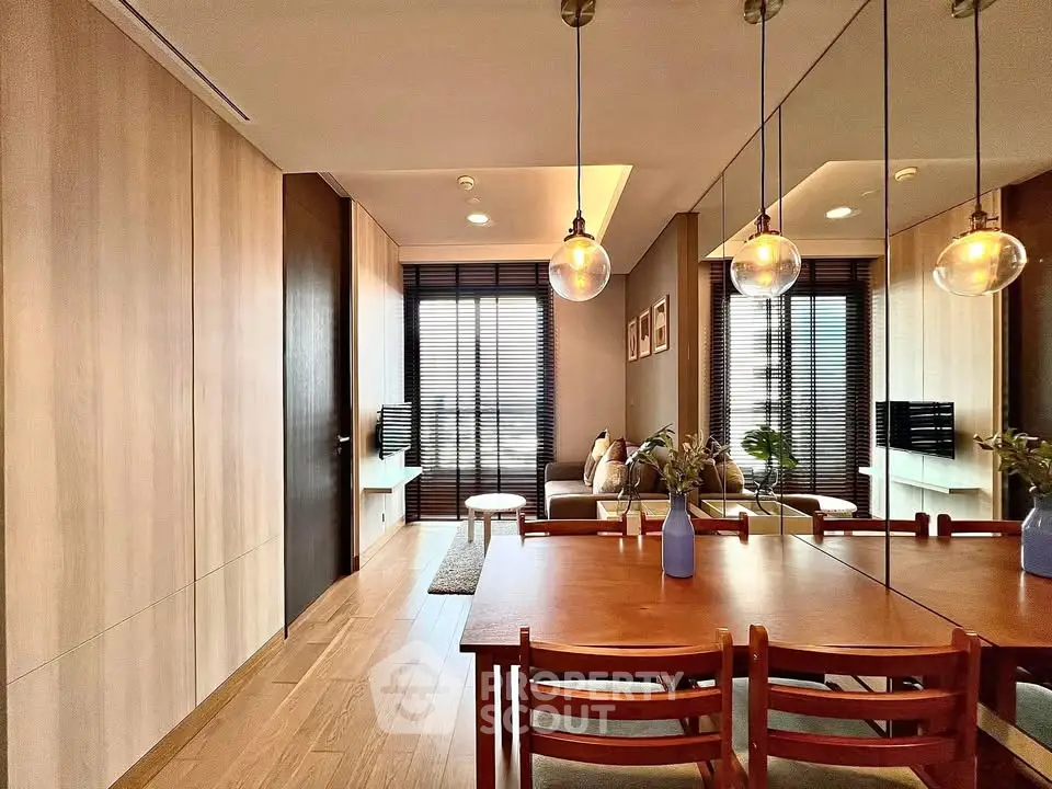 Modern living room with stylish decor and wooden accents, featuring a cozy seating area and elegant lighting.