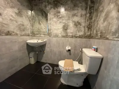 Modern bathroom with sleek gray tiles and contemporary fixtures