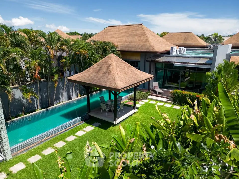 Luxurious villa with private pool and lush garden in tropical paradise setting.