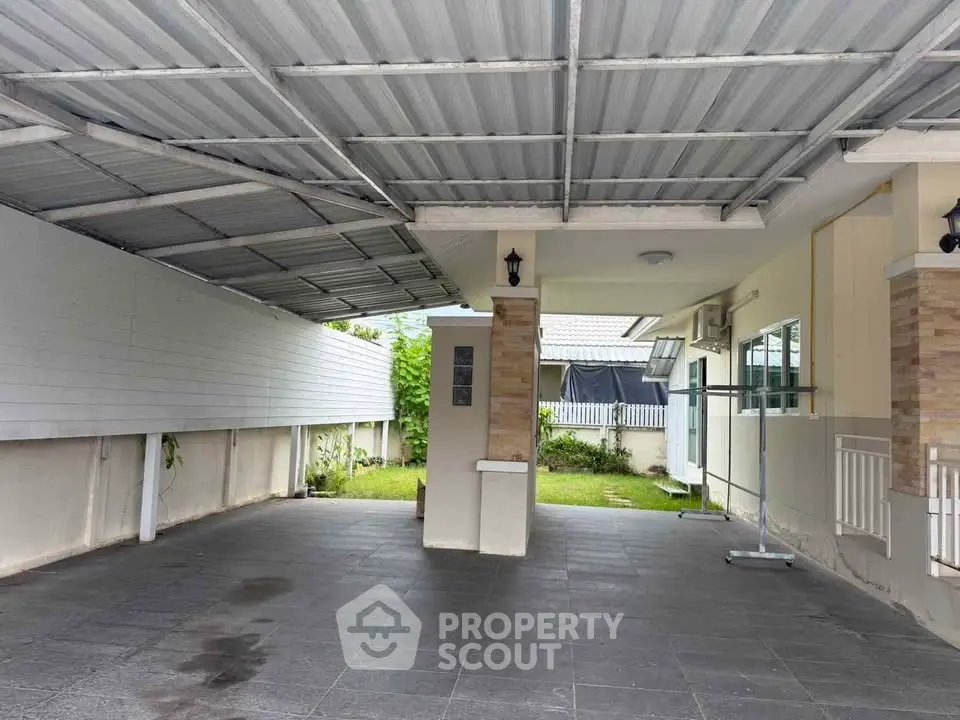 Spacious covered parking area with modern design and garden view