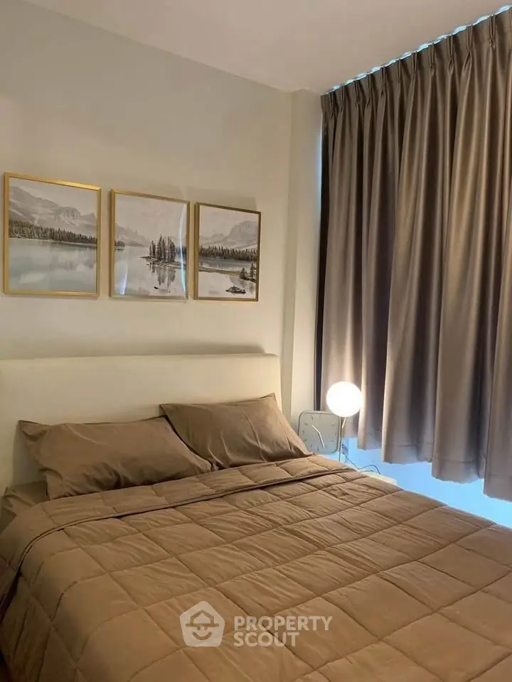 Cozy bedroom with elegant decor and soft lighting, featuring a comfortable bed and stylish curtains.