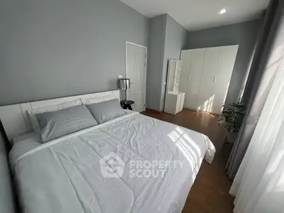 Spacious modern bedroom with sleek design and ample natural light