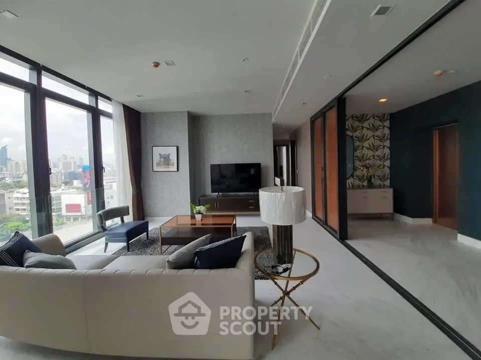 Luxurious modern living room with panoramic city views and elegant decor.