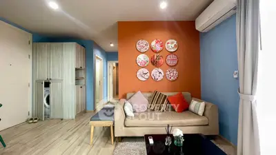 Charming living room with colorful decor and modern furnishings in a cozy apartment.