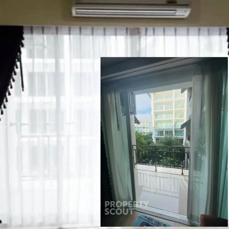 Spacious balcony with serene view and elegant curtains in modern apartment.