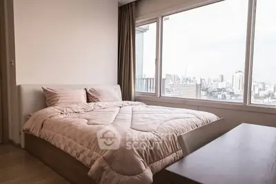 Modern bedroom with city view and large window, featuring cozy bedding and elegant decor.