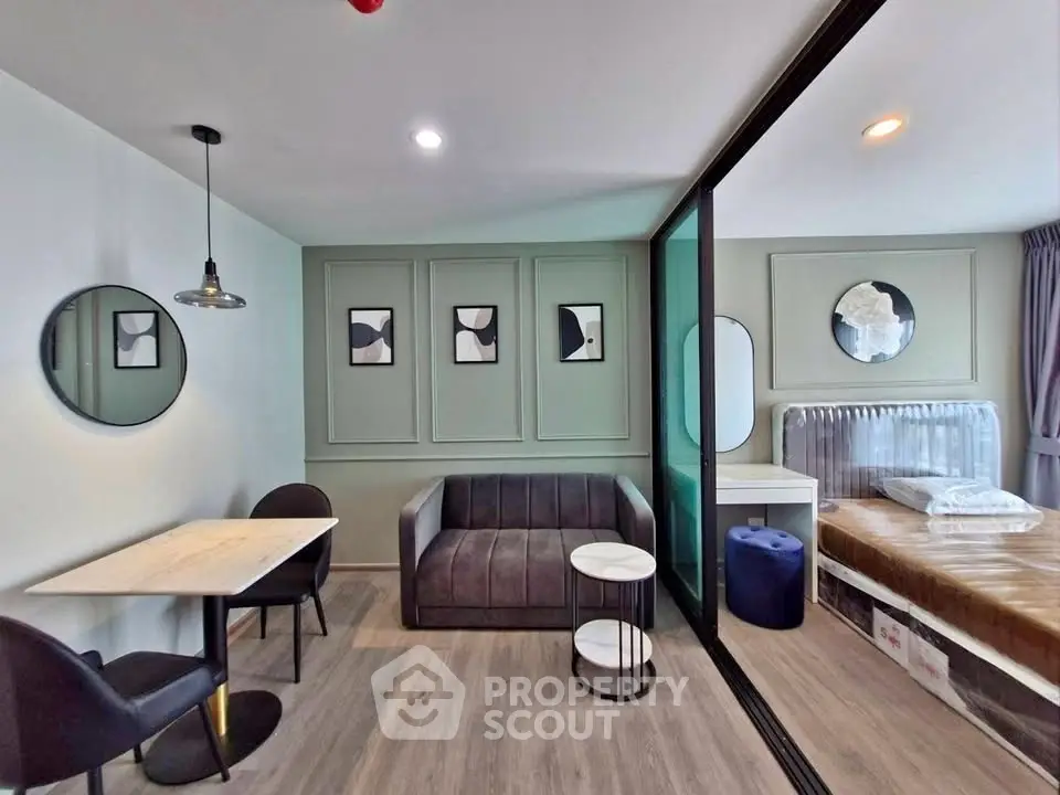 Modern studio apartment with stylish decor and open layout, featuring a cozy living area and bedroom.