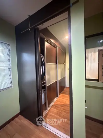 Spacious walk-in closet with sliding doors and ample storage space.