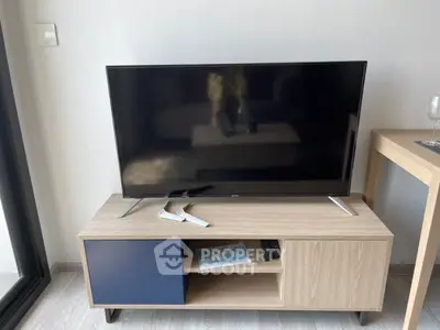 Modern living room with sleek TV stand and flat-screen TV, perfect for entertainment.