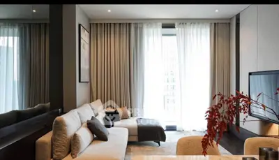 Modern living room with elegant decor and large windows for natural light.