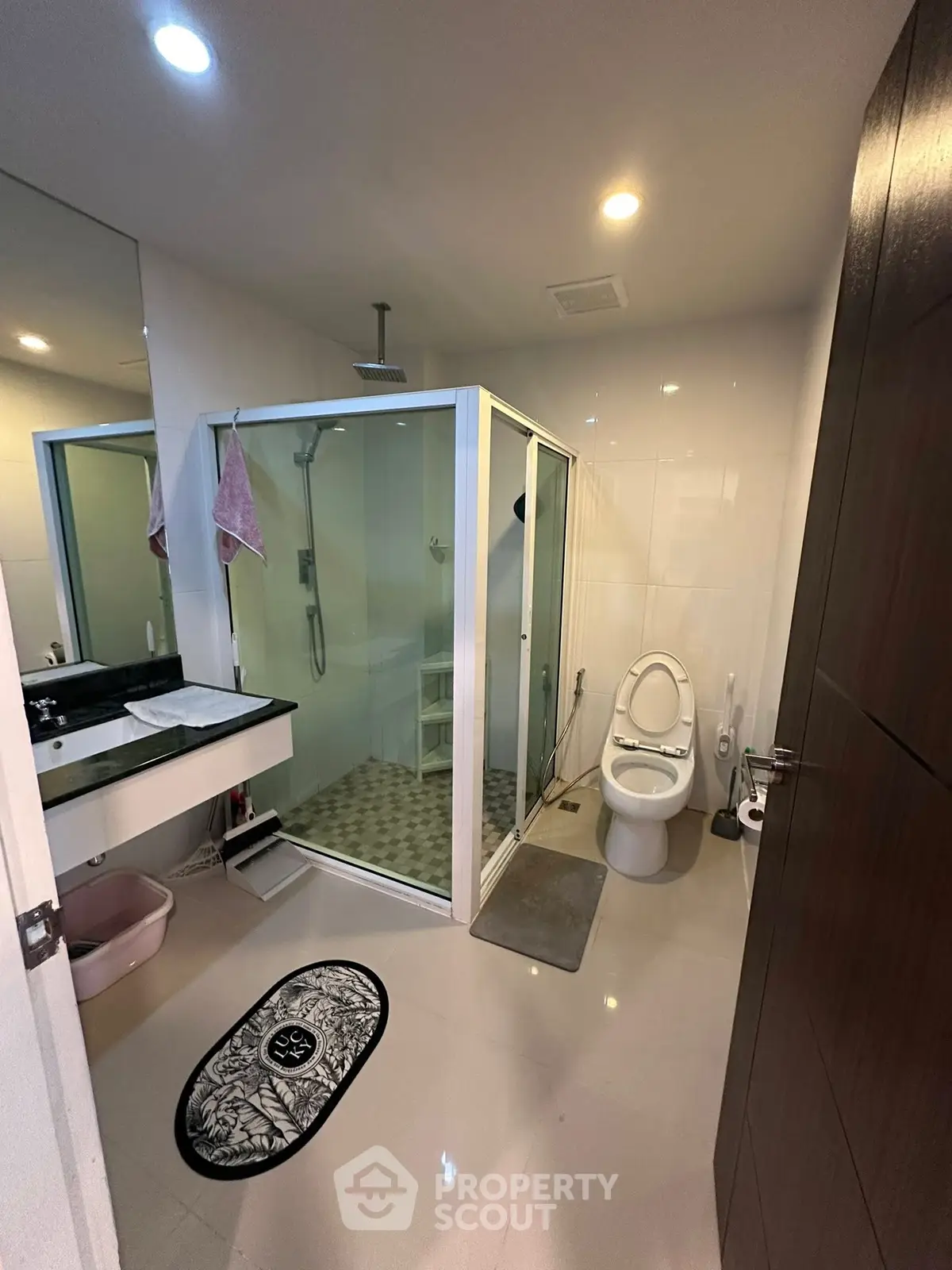 Modern bathroom with glass shower and sleek fixtures in a contemporary home.