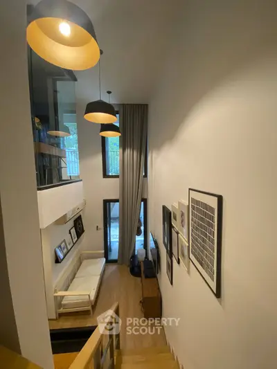 Modern loft-style living room with high ceilings and stylish decor