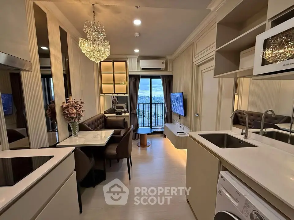 Luxurious modern living room with elegant chandelier and stunning city view from balcony.