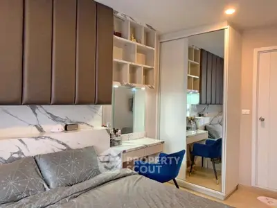 Modern bedroom with stylish decor and mirrored wardrobe