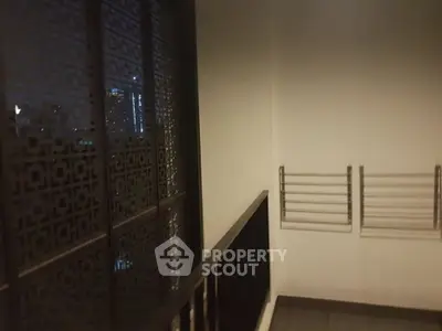 Modern balcony with city view and sleek railing design at night.