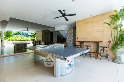 Luxurious recreational area with table tennis and bar seating in modern home
