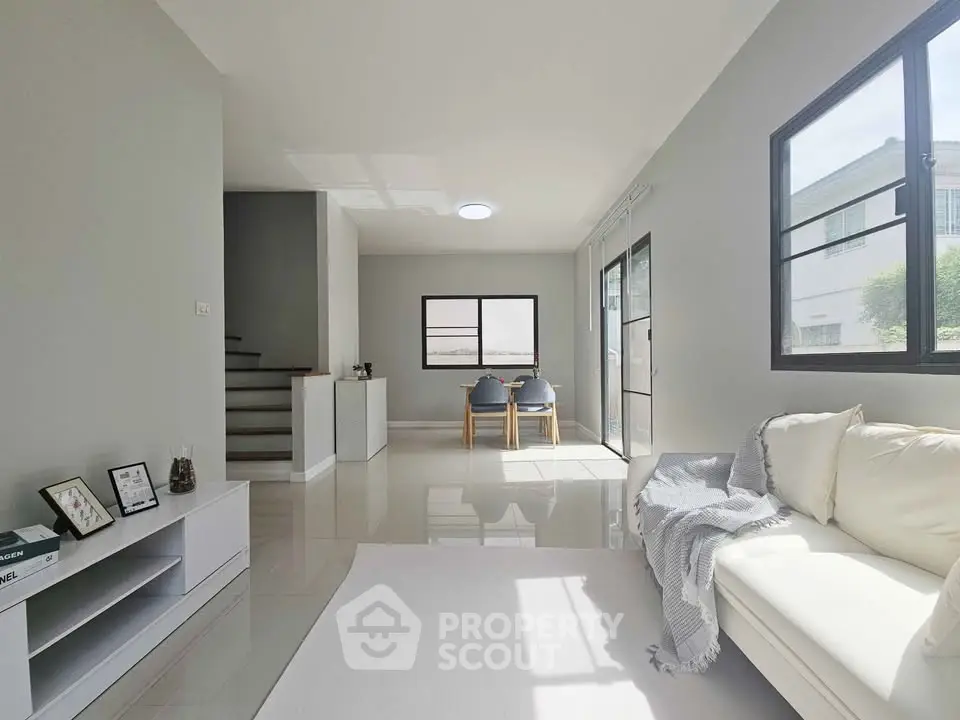 Bright modern living room with sleek furniture and large windows for natural light.