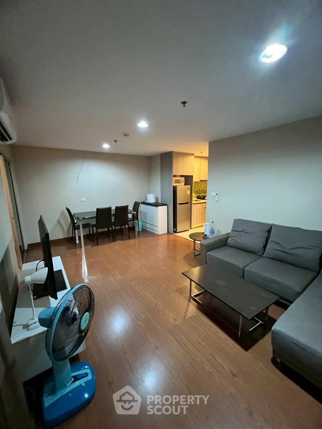 Spacious living room with modern furnishings and open kitchen layout