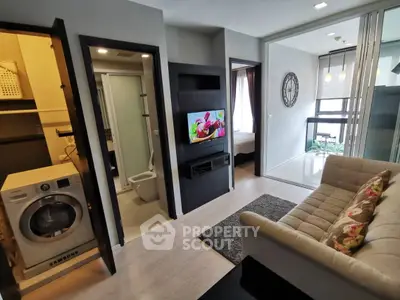 Modern apartment interior with living room, washing machine, and stylish decor