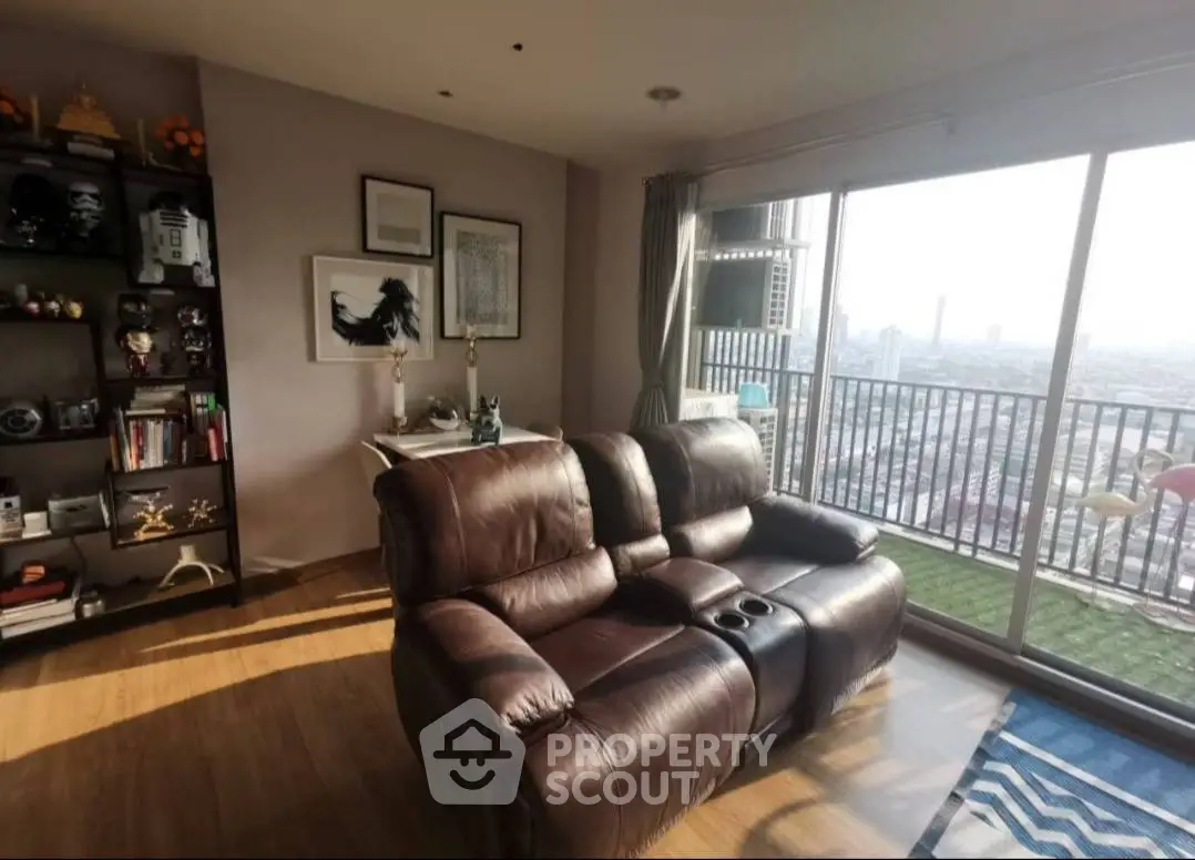Stylish living room with leather sofa and city view balcony in modern apartment
