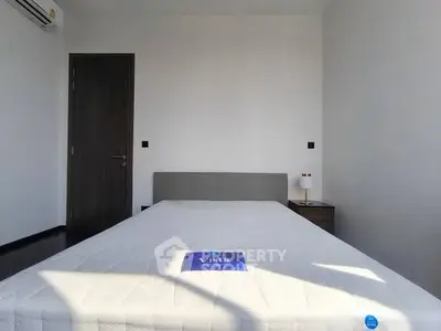 Modern minimalist bedroom with sleek design and ample natural light.