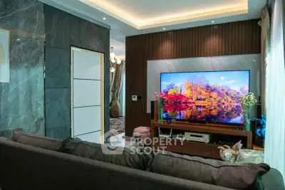 Luxurious living room with modern decor and large flat-screen TV