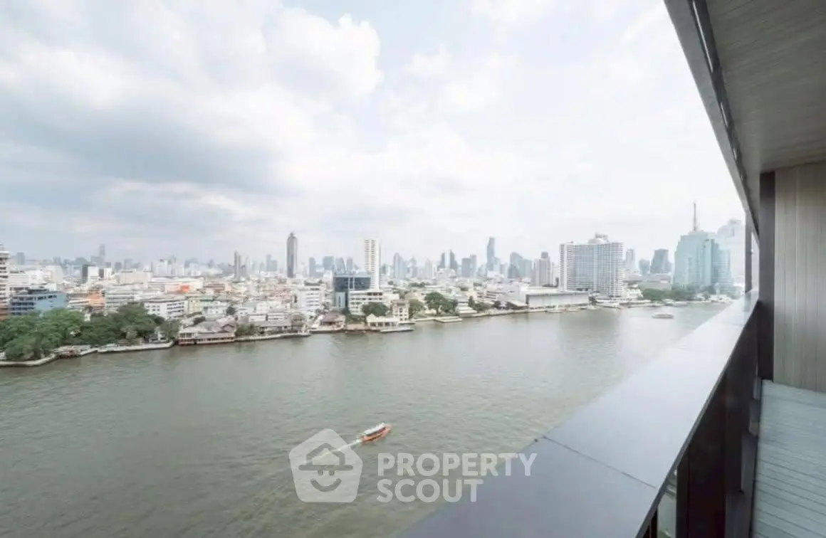Stunning river view from high-rise balcony overlooking city skyline.