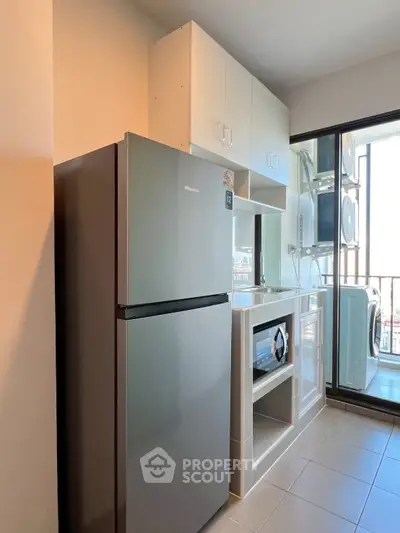Modern kitchen with sleek appliances and balcony view