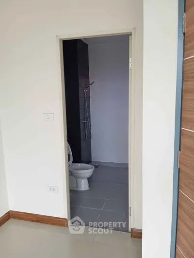 Modern bathroom with sleek shower and toilet in a minimalist design