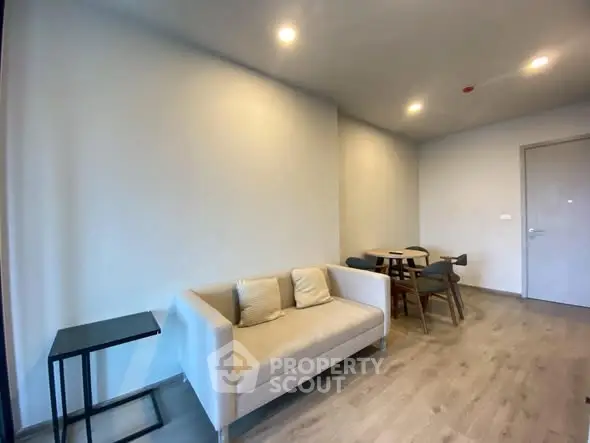 Modern living room with cozy sofa and dining area in minimalist style.