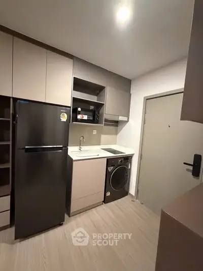 Modern compact kitchen with sleek appliances and minimalist design