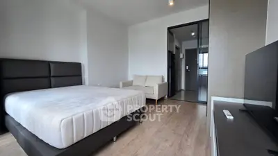 Modern bedroom with minimalist design and cozy ambiance in a stylish apartment.