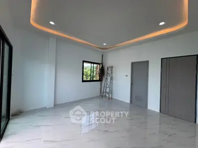 Spacious modern room with elegant ceiling lighting and marble flooring