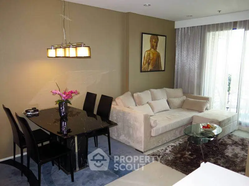 Modern living room with elegant dining area and cozy sofa, featuring stylish decor and natural light.