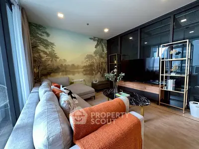 Stylish living room with modern decor and scenic wall art, featuring a cozy sofa and entertainment center.